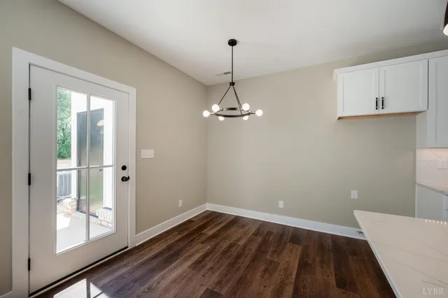 a view of a room with wooden floor and a ceiling fan