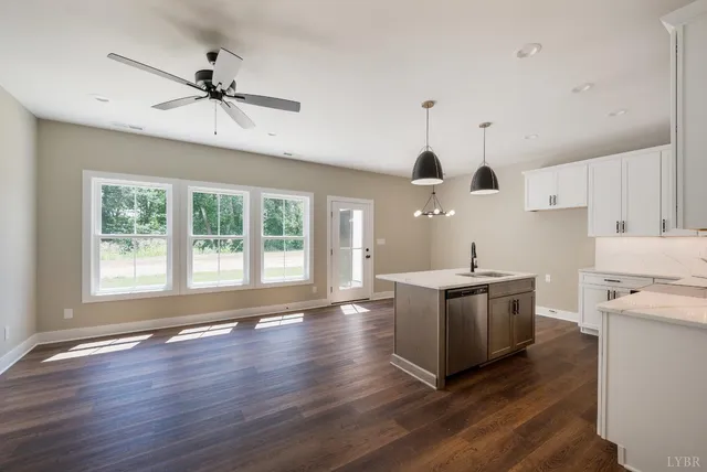 a kitchen with stove and wooden floor