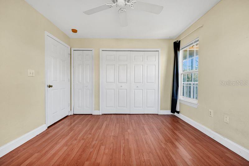 5471 Vineland Road, Unit 7301 Orlando, FL 32811 - Photo 12 of 34 a view of an empty room with wooden floor and a window