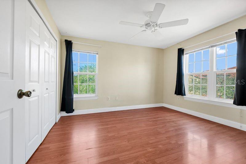 5471 Vineland Road, Unit 7301 Orlando, FL 32811 - Photo 14 of 34 a view of an empty room with a window and wooden floor