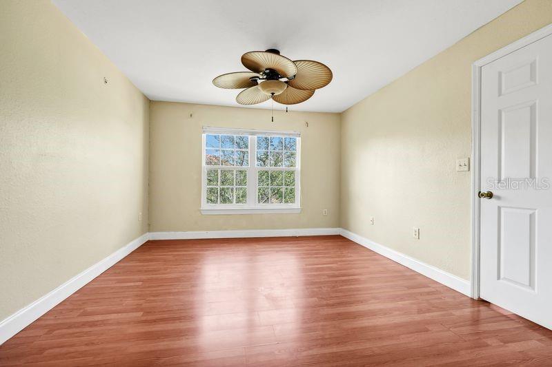 5471 Vineland Road, Unit 7301 Orlando, FL 32811 - Photo 15 of 34 an empty room with wooden floor and windows