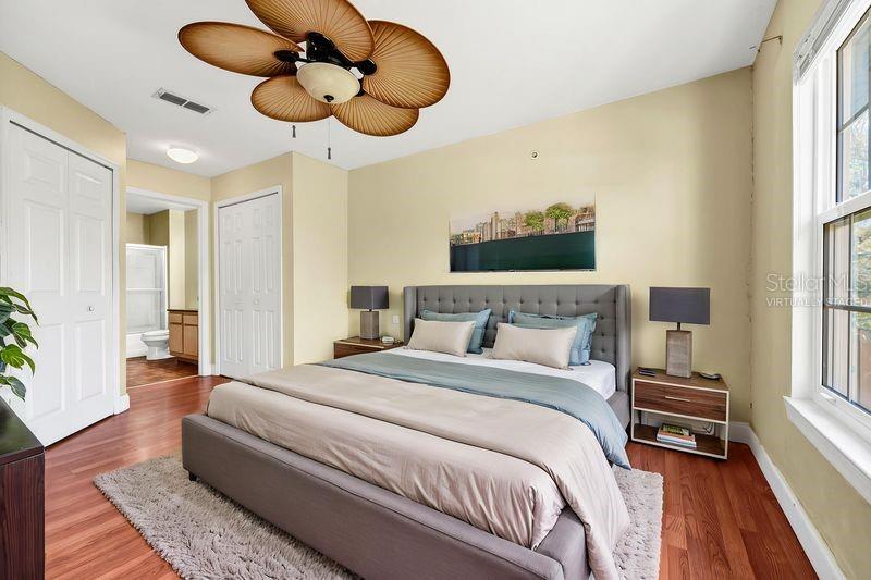 5471 Vineland Road, Unit 7301 Orlando, FL 32811 - Photo 16 of 34 a bedroom with a bed and a chandelier