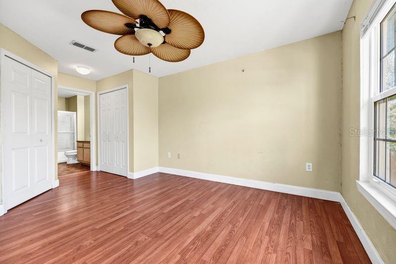 5471 Vineland Road, Unit 7301 Orlando, FL 32811 - Photo 17 of 34 a view of an empty room with wooden floor and a window