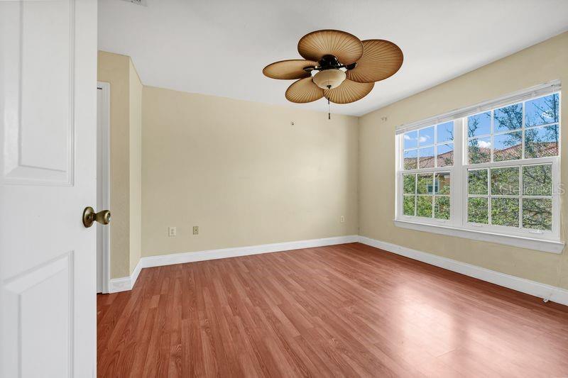 5471 Vineland Road, Unit 7301 Orlando, FL 32811 - Photo 18 of 34 a view of an empty room with wooden floor and a window