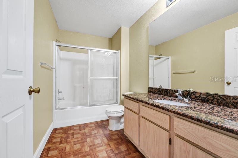 5471 Vineland Road, Unit 7301 Orlando, FL 32811 - Photo 20 of 34 a bathroom with a granite countertop sink toilet and shower