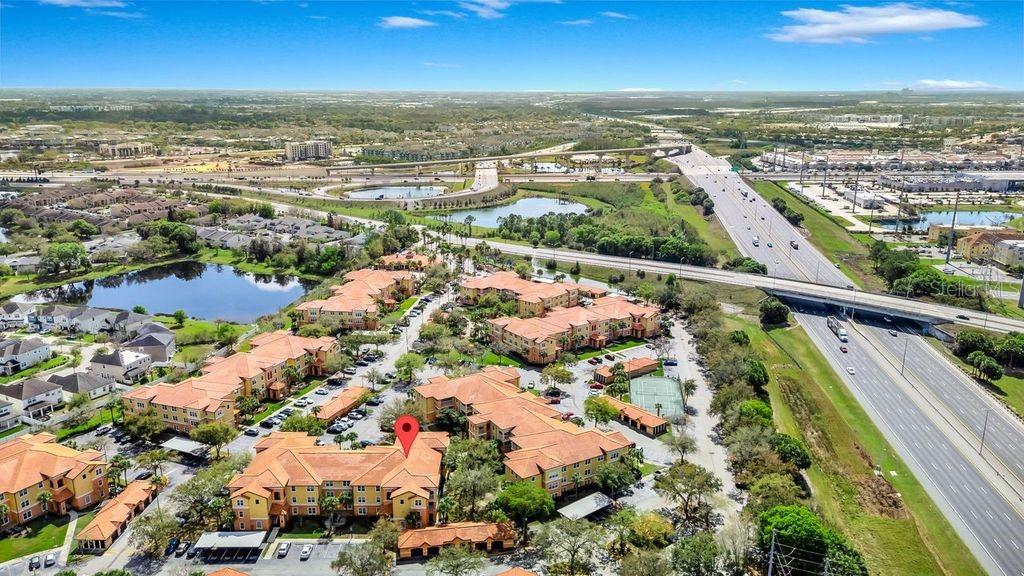 5471 Vineland Road, Unit 7301 Orlando, FL 32811 - Photo 27 of 34 an aerial view of residential building and lake