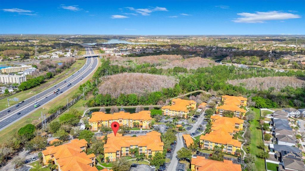 5471 Vineland Road, Unit 7301 Orlando, FL 32811 - Photo 32 of 34 an aerial view of residential houses with outdoor space