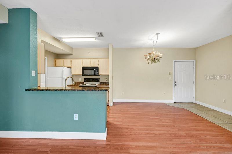 5471 Vineland Road, Unit 7301 Orlando, FL 32811 - Photo 6 of 34 a view of a kitchen with marble kitchen and refrigerator
