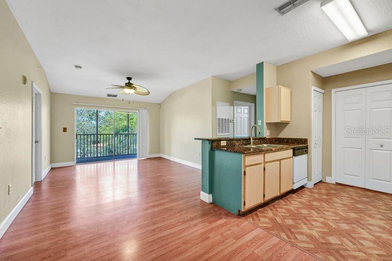 5471 Vineland Road, Unit 7301 Orlando, FL 32811 - Photo 7 of 34 a kitchen with stainless steel appliances granite countertop a stove top oven and sink