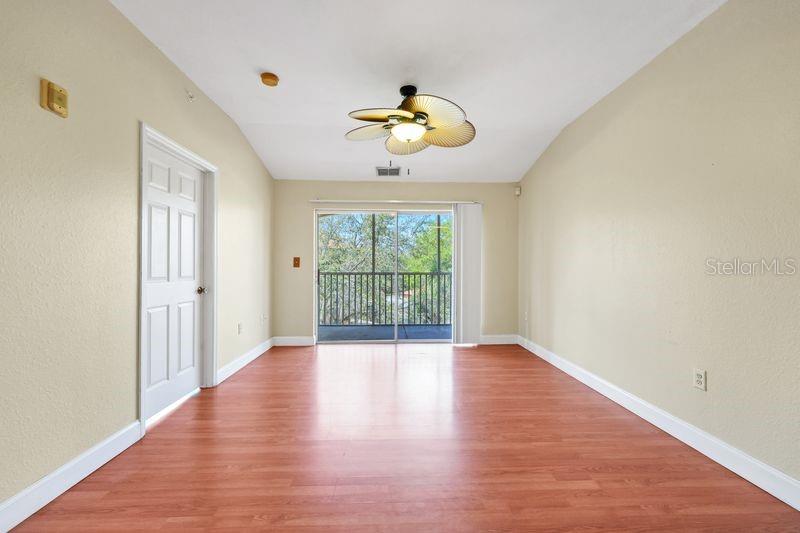 5471 Vineland Road, Unit 7301 Orlando, FL 32811 - Photo 8 of 34 wooden floor in an empty room with a window