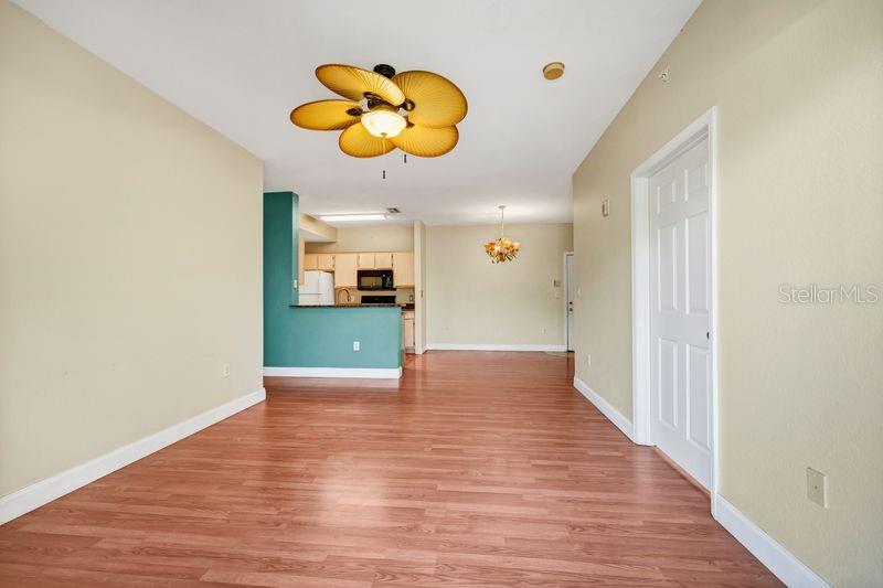 5471 Vineland Road, Unit 7301 Orlando, FL 32811 - Photo 9 of 34 a view of an empty room and wooden floor