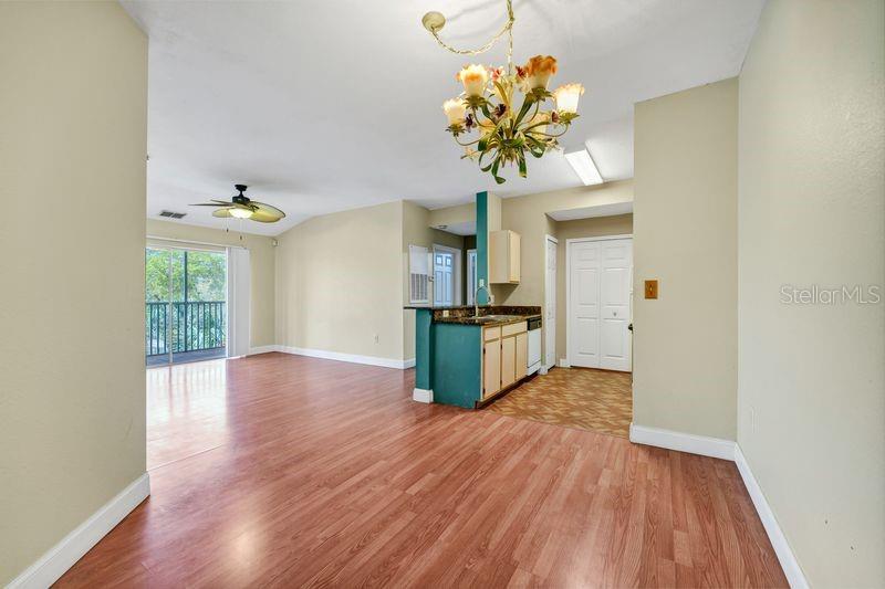 5471 Vineland Road, Unit 7301 Orlando, FL 32811 - Photo 10 of 34 a view of a kitchen with wooden floor and a refrigerator