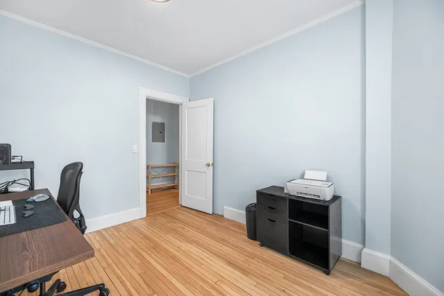 a room with wooden floor and furniture