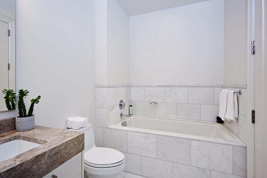 1 Franklin Street, Unit 3409 Boston, MA 02110 - Photo 13 of 18 a bathroom with a sink a toilet and tub