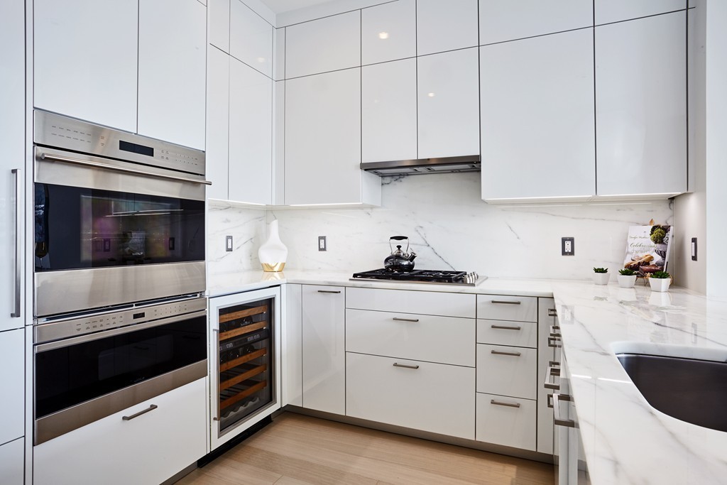 1 Franklin Street, Unit 3409 Boston, MA 02110 - Photo 6 of 18 a kitchen with cabinets stainless steel appliances and sink
