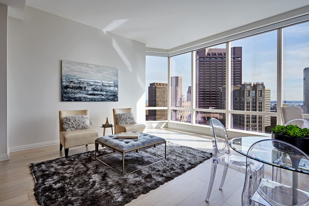 1 Franklin Street, Unit 3409 Boston, MA 02110 - Photo 8 of 18 a living room with furniture and a floor to ceiling window