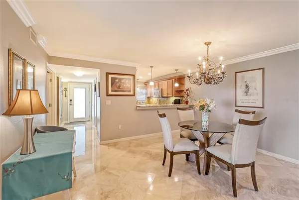 a view of a dining room with furniture and chandelier