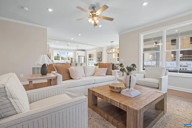 a living room with furniture a table and a chandelier