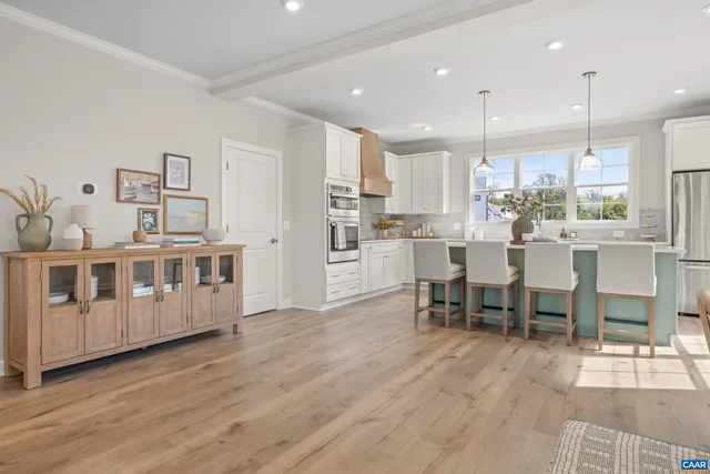 a large kitchen with lots of counter space and furniture