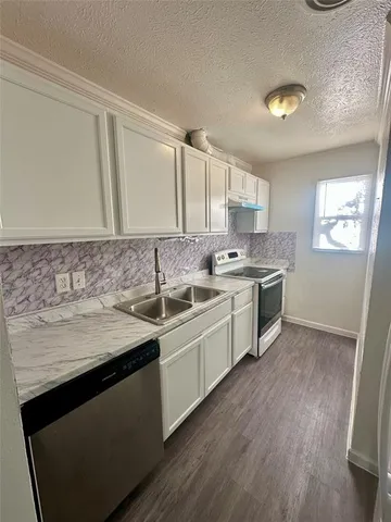a kitchen with stainless steel appliances granite countertop a sink stove and cabinets
