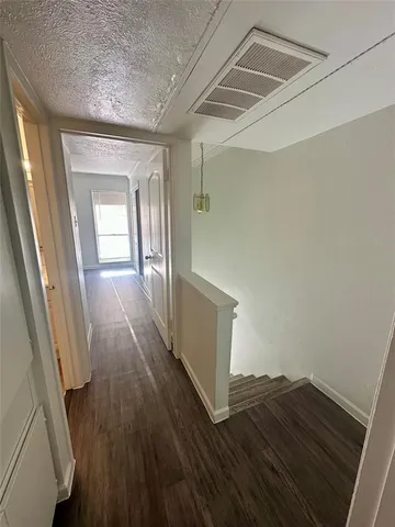 a view of a room with wooden floor and staircase