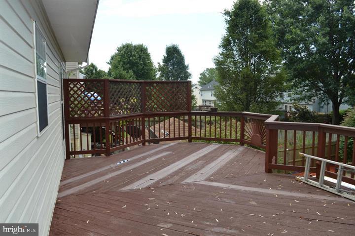 9300 Nancy Street Manassas Park, VA 20111 - Photo 6 of 22 a view of a balcony with trees and wooden fence