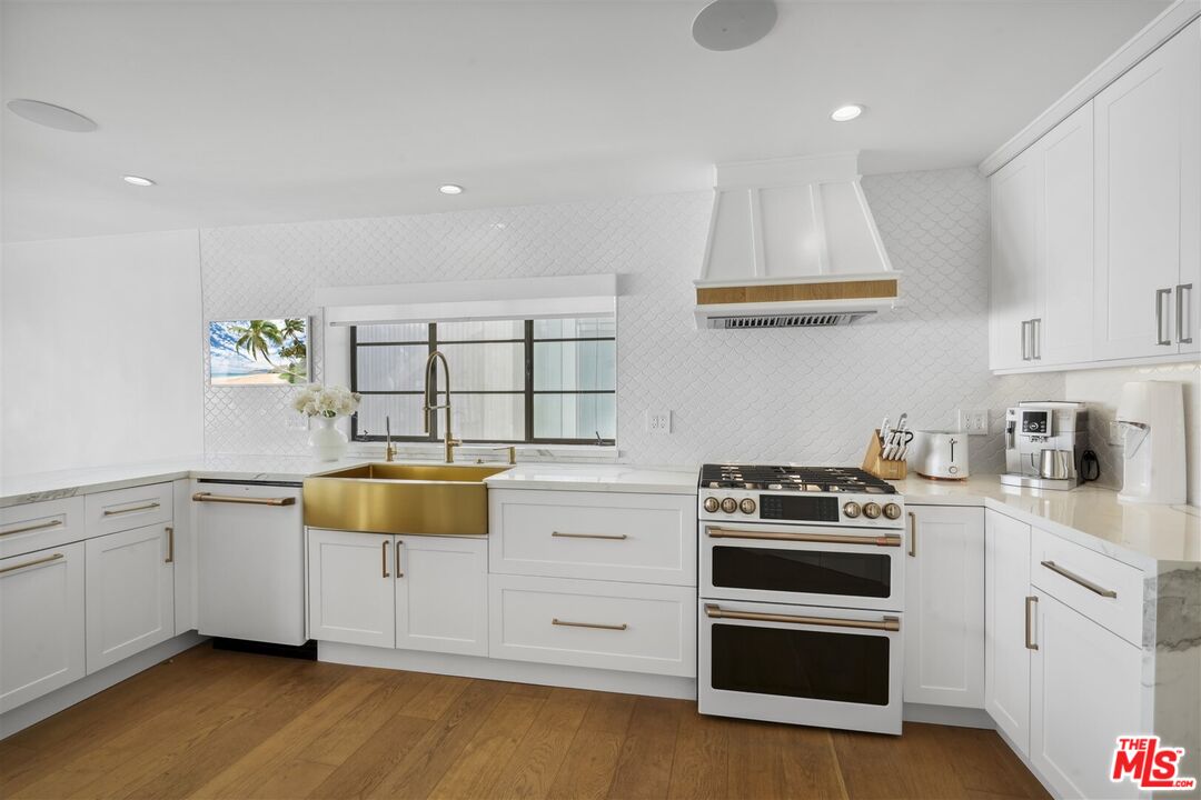 31500 Victoria Point Road Malibu, CA 90265 - Photo 13 of 53 a kitchen with a stove and white cabinets