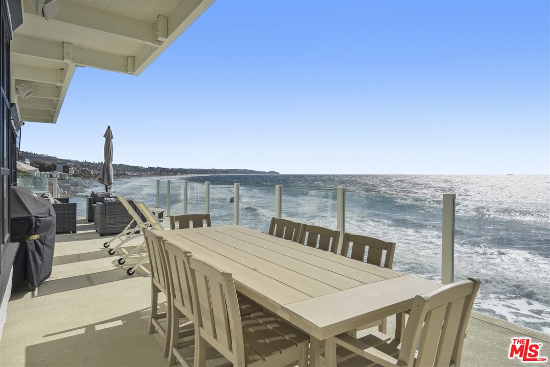 31500 Victoria Point Road Malibu, CA 90265 - Photo 15 of 53 a view of a balcony with furniture and wooden floor