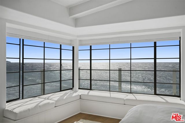 a spacious bedroom with a bed and a fireplace