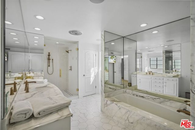 a bathroom with a sink a vanity and a bathtub