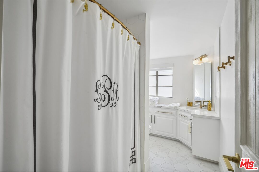31500 Victoria Point Road Malibu, CA 90265 - Photo 43 of 53 a bathroom with a sink a mirror and a shower