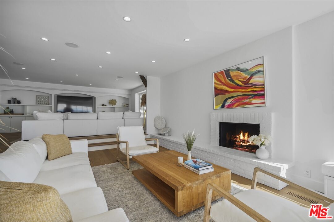 31500 Victoria Point Road Malibu, CA 90265 - Photo 6 of 53 a living room with furniture and a fireplace