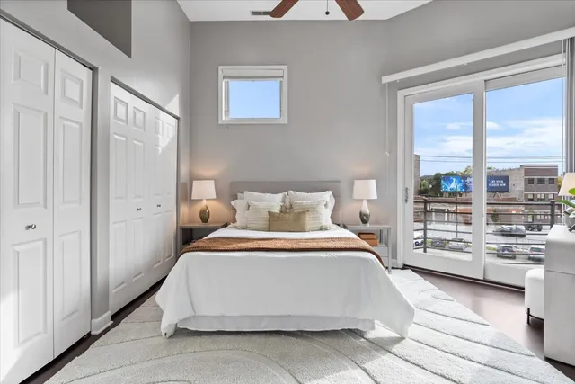 a bedroom with a large bed and a large window