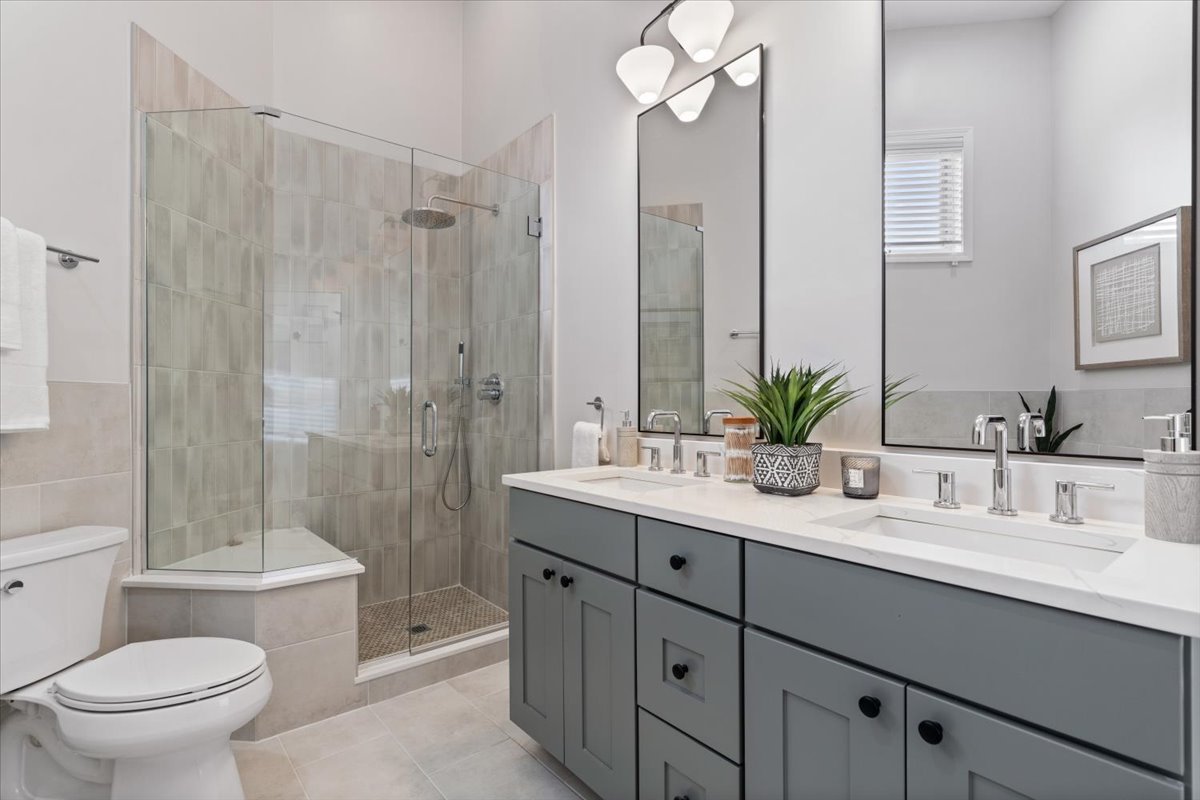 932 North Racine Avenue, Unit 2S Chicago, IL 60642 - Photo 18 of 29 a bathroom with a sink a toilet a large mirror and shower