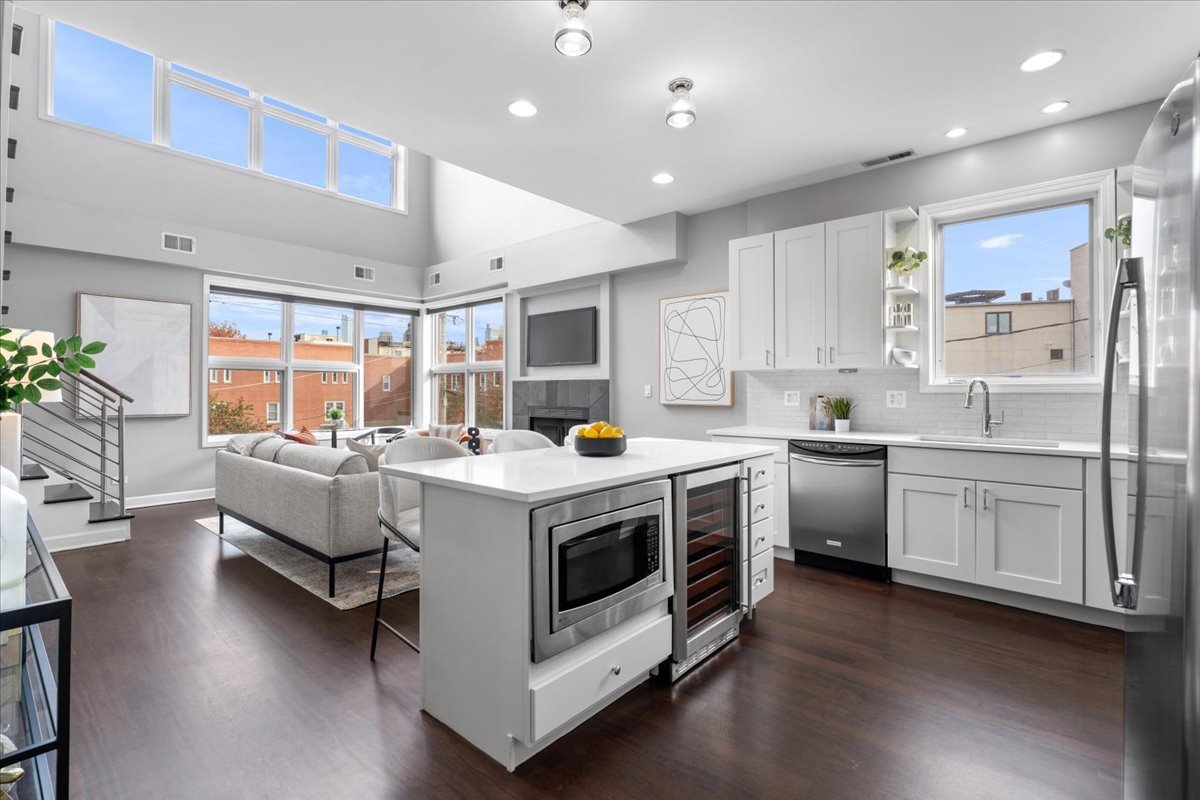 932 North Racine Avenue, Unit 2S Chicago, IL 60642 - Photo 2 of 29 a kitchen that has a lot of white cabinets and wooden floor