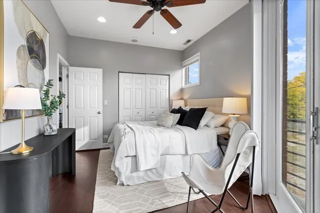 a bed room with a bed window and a chair