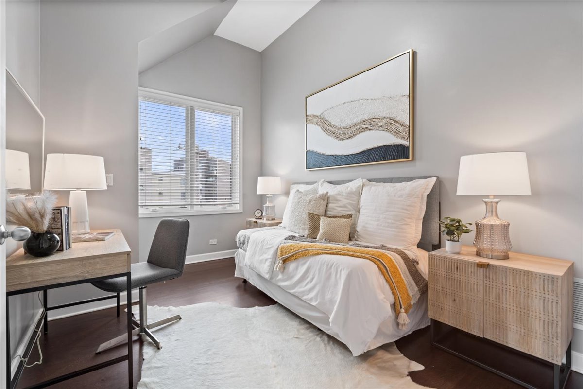 932 North Racine Avenue, Unit 2S Chicago, IL 60642 - Photo 22 of 29 a bedroom with a bed a lamp on desk and a window