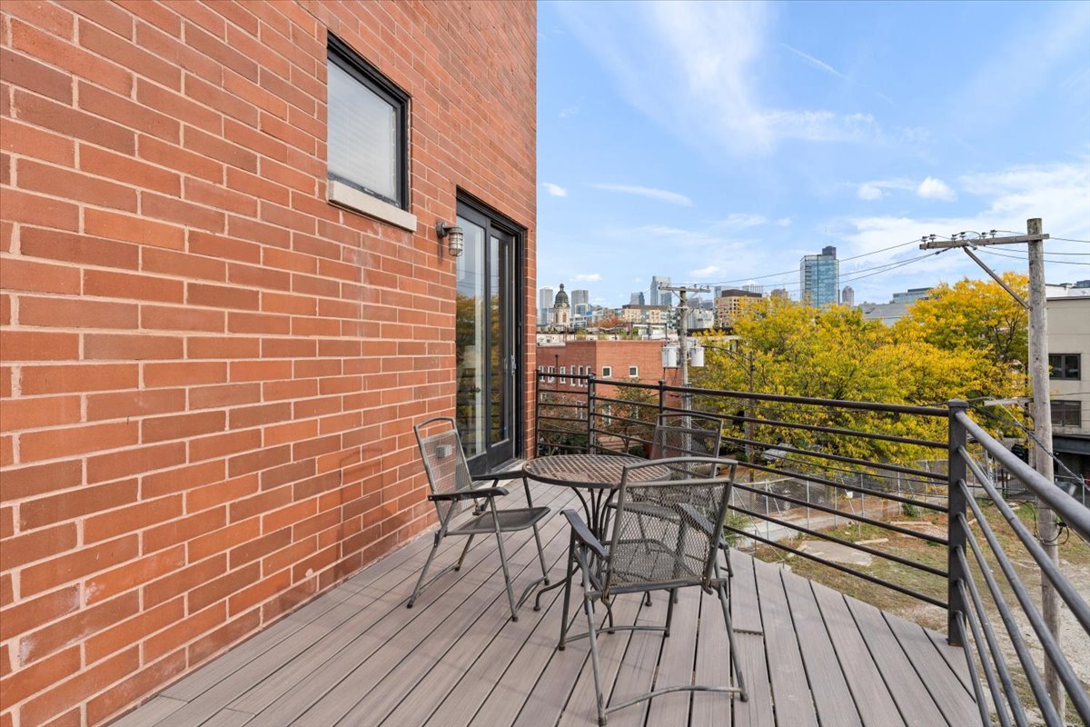 932 North Racine Avenue, Unit 2S Chicago, IL 60642 - Photo 25 of 29 a view of a balcony with wooden floor