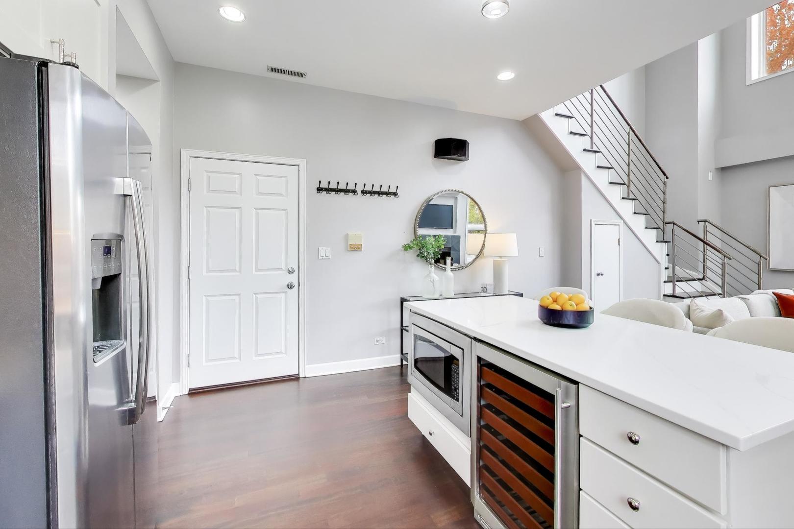 932 North Racine Avenue, Unit 2S Chicago, IL 60642 - Photo 4 of 29 a kitchen view with stainless steel appliances a sink dishwasher stove and refrigerator