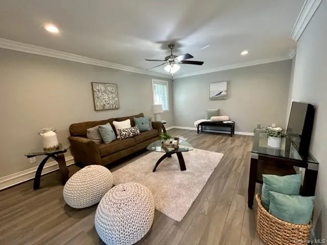 a living room with furniture and a hard wood floor