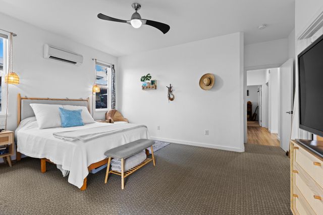 a bedroom with a bed and a flat tv screen