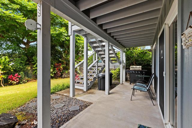 a view of a porch with chairs and backyard