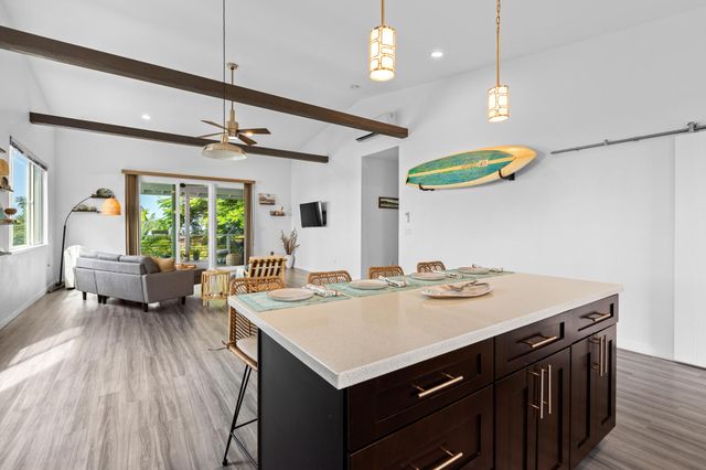 a kitchen with a stove a refrigerator and a table