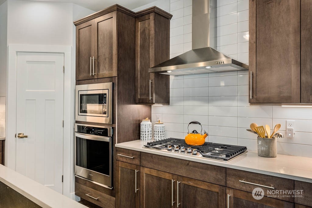 19 177th St S West Bothell, WA 98012 - Photo 7 of 29 a kitchen with stainless steel appliances a stove and a refrigerator