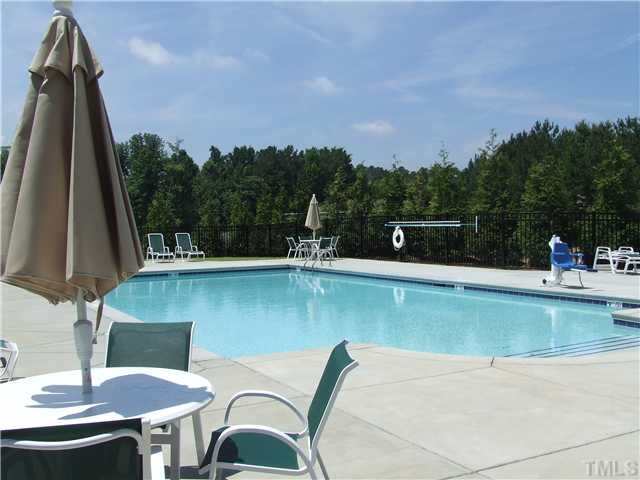 7803 Lillyhurst Drive Raleigh, NC 27612 - Photo 12 of 25 a view of a swimming pool with a patio