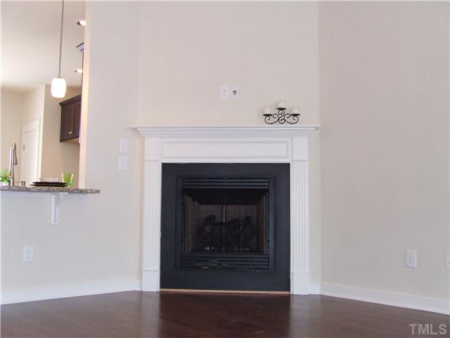 7803 Lillyhurst Drive Raleigh, NC 27612 - Photo 2 of 25 a white building with a fireplace