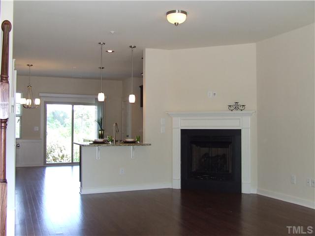 7803 Lillyhurst Drive Raleigh, NC 27612 - Photo 3 of 25 a view of a kitchen with furniture and wooden floor