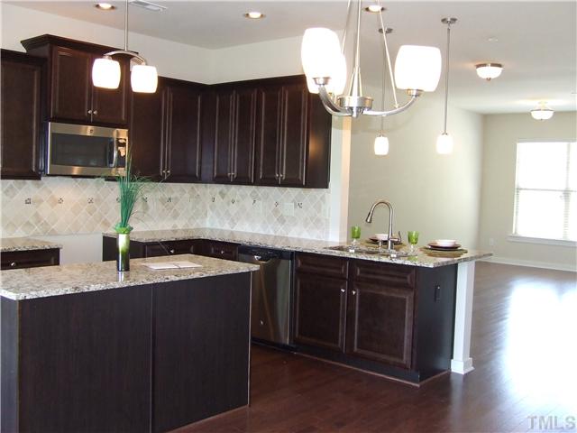 7803 Lillyhurst Drive Raleigh, NC 27612 - Photo 4 of 25 a kitchen with a sink and a cabinets