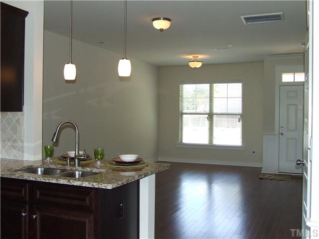 7803 Lillyhurst Drive Raleigh, NC 27612 - Photo 6 of 25 a kitchen with a sink and chandelier