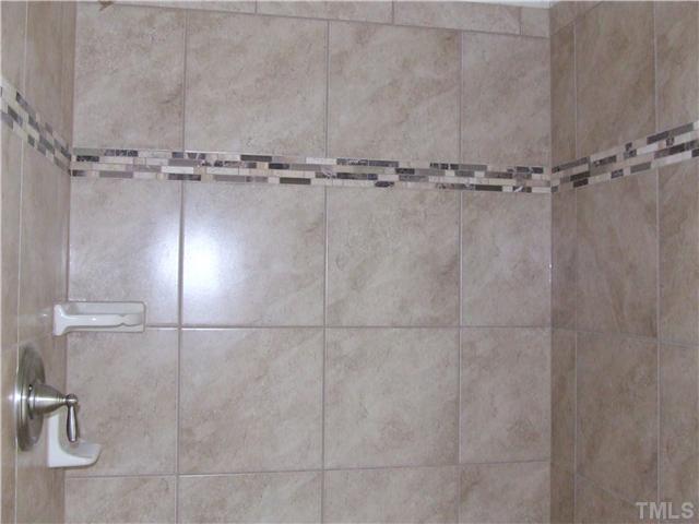 7803 Lillyhurst Drive Raleigh, NC 27612 - Photo 7 of 25 a bathroom with a shower